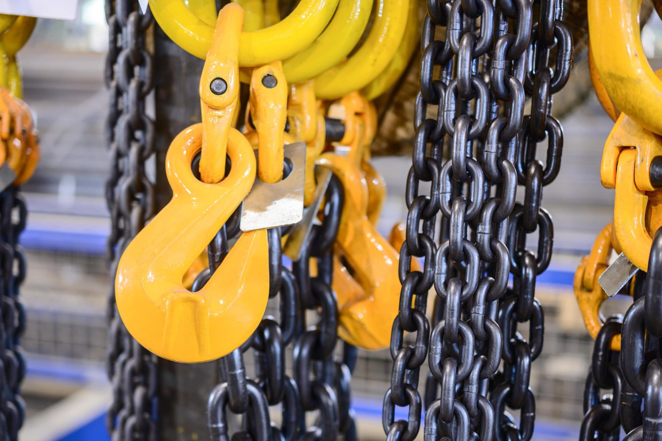 A close up image of chains and hooks for lifting heavy equipment